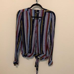 Cute wrap blouse with shiny detail woven throughout. Fun for work or weekend.